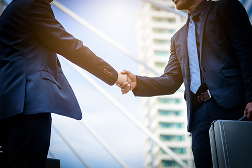 Successful partnership handshake after purchase NCR ITM